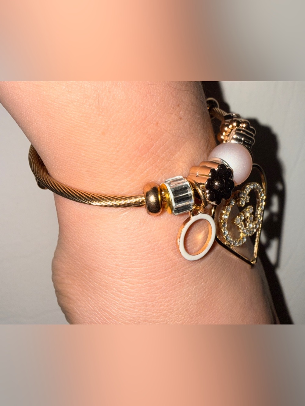 Gold-Tone Cable Bangle Bracelet with White and Black Charm Accents